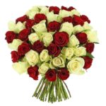 Beautiful combination of red roses and white roses in a hand bunch bouquet from JuneFlowers.com