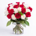 Romantic red and white roses in a cylindrical vase from JuneFlowers.com