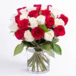 Romantic red and white roses in a cylindrical vase from JuneFlowers.com